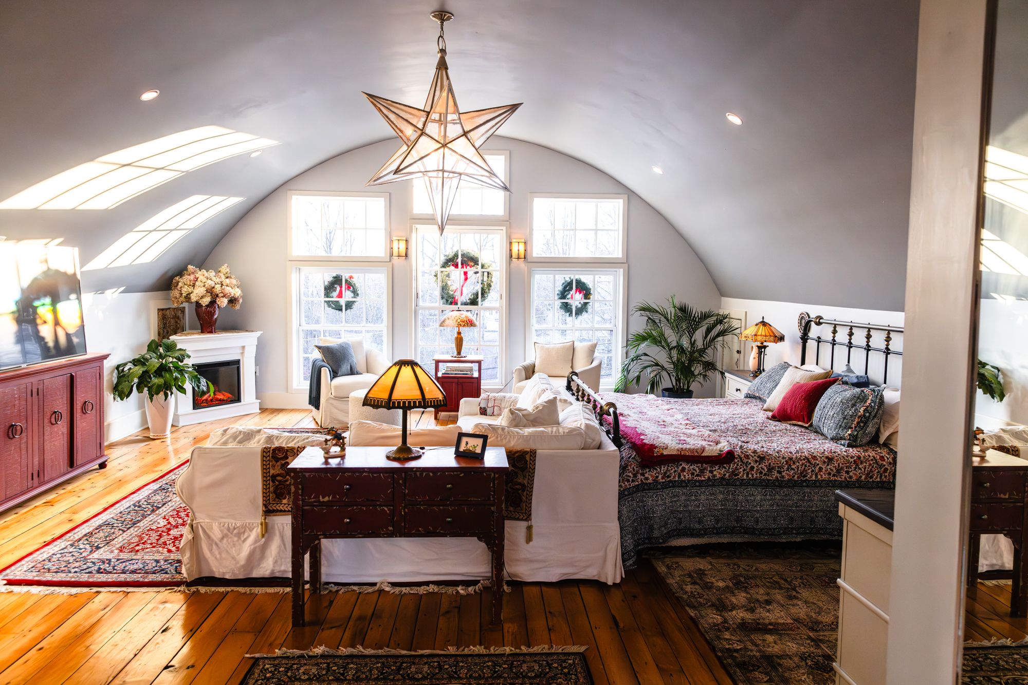 The primary suite with a soaring vaulted ceiling and star pendant light